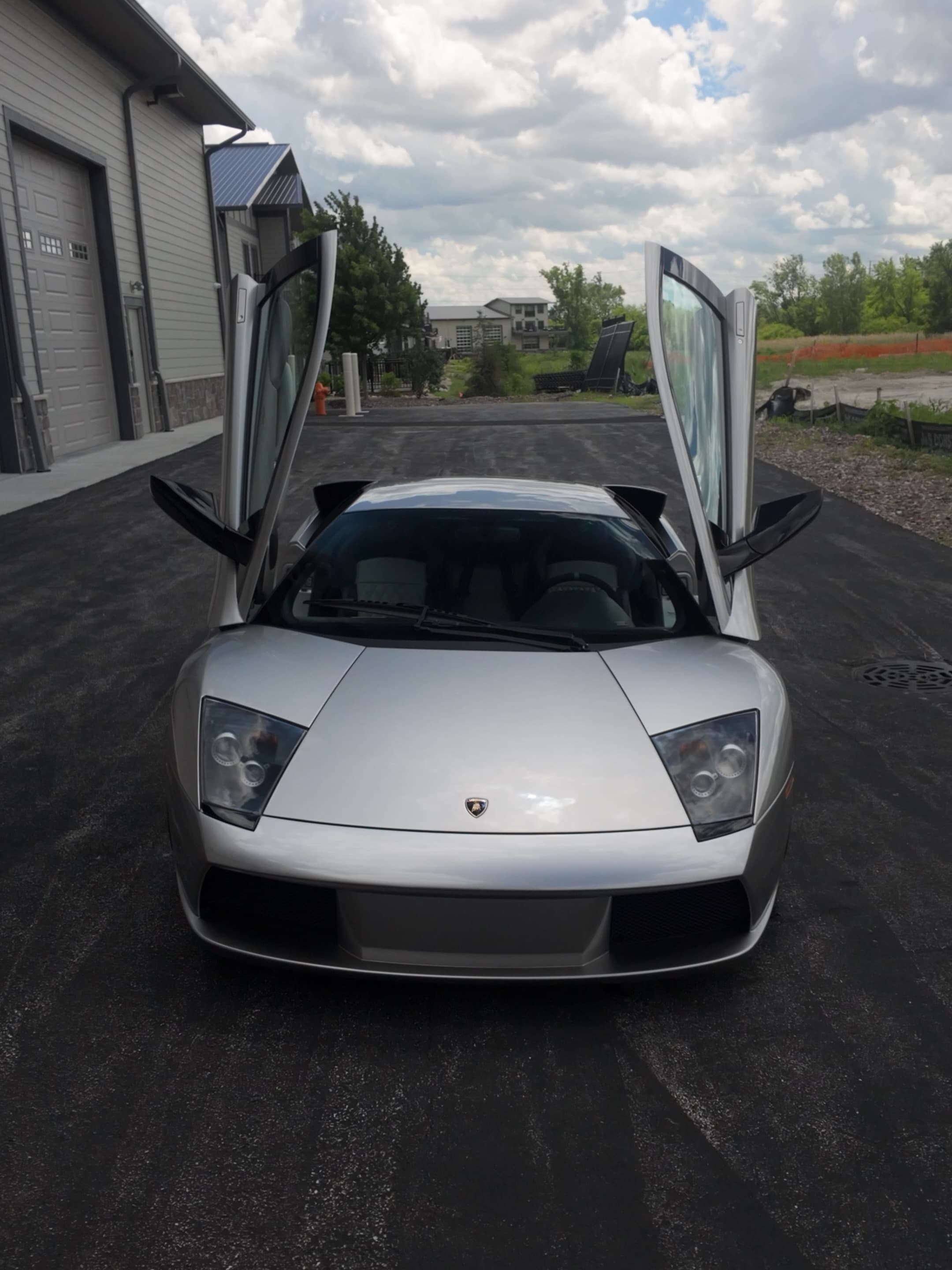 Silver Lamborghini with scissor doors open